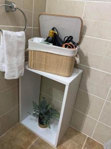 a basket on top of a white shelf in a bathroom at Apartament Terra II in Floreşti