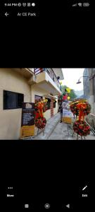 a picture of a building with chairs with flowers on them at Kylitas transient house studio apartment 1st floor in Tagbilaran City