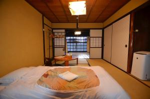 a room with a bed and a table in it at Colours in Kyoto