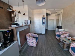 a living room with two chairs and a table at Hotel H pe plaja Belona in Eforie Nord