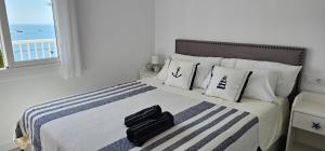 a bedroom with a bed with a suitcase on it at Apartamento Canyelles playa in Roses