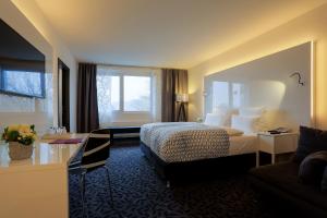 Cama ou camas em um quarto em FourSide Plaza Hotel Trier, Trademark Collection by Wyndham