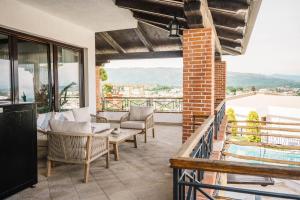 a living room with chairs and a table on a balcony at Apartments Bazar in Ulcinj