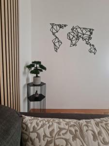 a bedroom with a bed and a plant on a wall at Cicibela Apartment - Zadar in Zadar