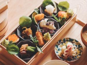 two bento boxes filled with different types of food at SOKI Kanazawa in Kanazawa