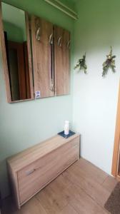 a room with a dresser and a mirror on the wall at Apartment Sopar in Škofja Loka