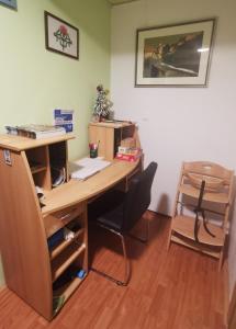 an office with a wooden desk and a chair at Apartment Sopar in Škofja Loka