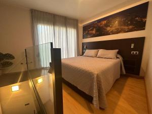 Cama ou camas em um quarto em Precioso dúplex en el centro de Tarragona