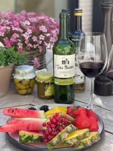 a plate of fruit and a bottle of wine and a glass at ABC Hotel in Blankenberge