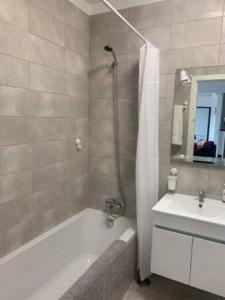 a bathroom with a shower and a tub and a sink at Nossa Casa - 2 Bedroom Apartment in Alvor in Alvor