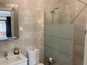 a bathroom with a shower and a toilet and a sink at Nossa Casa - 2 Bedroom Apartment in Alvor in Alvor