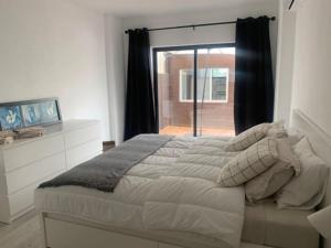 a bedroom with a large bed and a window at Nossa Casa - 2 Bedroom Apartment in Alvor in Alvor