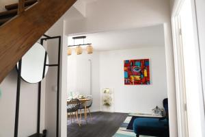 a living room with a blue couch and a table at Très Belle MAISON à Rennes St Jacques in Saint-Jacques-de-la-Lande