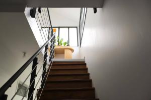 a staircase in a house with white walls at Très Belle MAISON à Rennes St Jacques in Saint-Jacques-de-la-Lande