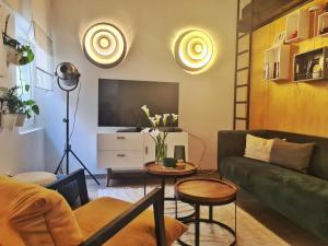 a living room with a couch and a tv at Grisia 26 Apartment in Rovinj