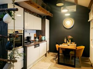 a kitchen with a table and a small table and chairs at Grisia 26 Apartment in Rovinj