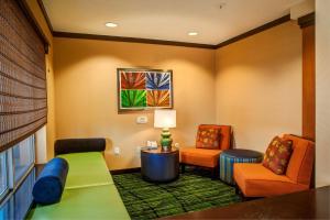 a hotel room with a bed and two chairs at Fairfield Inn and Suites by Marriott Indianapolis/ Noblesville in Noblesville