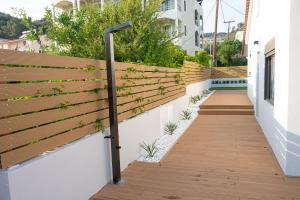 a wooden fence with plants on the side of a building at Orsalia villa wellness in Poros