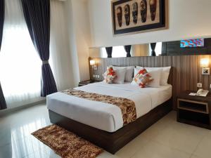 a bedroom with a large bed in a room at Vega Prime Hotel & Convention in Sorong