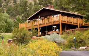 a large wooden house with a deck on the side at McGregor Mountain Lodge in Estes Park