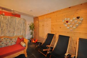 a living room with a couch and two chairs at Villa Natur in Schröcken