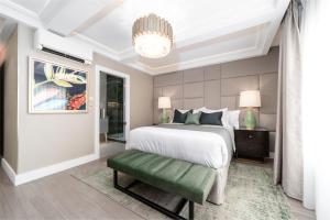 a bedroom with a large white bed and a chandelier at No.4 Carlton in Southampton