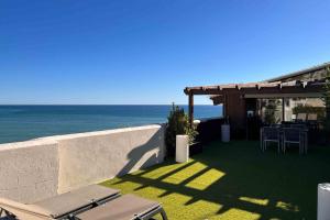 a patio with a view of the ocean at Estela Barcelona in Sitges