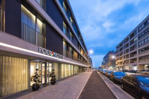 a street with cars parked in front of a building at Four Points by Sheraton Matosinhos in Matosinhos