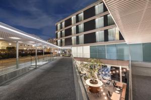 an external view of a building at night at Four Points by Sheraton Matosinhos in Matosinhos