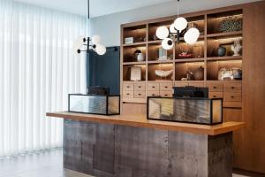 a kitchen with a wooden counter with two lights at Four Points by Sheraton Matosinhos in Matosinhos