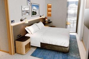 a bedroom with a large bed and a balcony at Four Points by Sheraton Matosinhos in Matosinhos