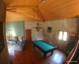 a living room with a pool table in it at Rilhadas Casas de Campo in Fafe