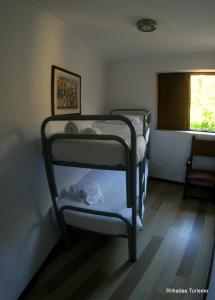 two bunk beds in a room with a window at Rilhadas Casas de Campo in Fafe