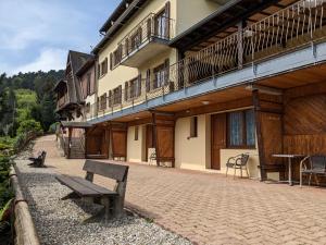 a bench sitting outside of a building with a balcony at La source in Sondernach