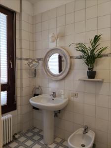 a bathroom with a sink and a mirror and a toilet at Cairoli20 in Vicenza