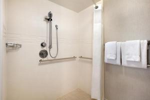 a bathroom with a shower with white towels at Residence Inn by Marriott Baltimore Downtown/ Inner Harbor in Baltimore