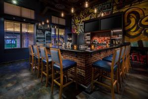 a bar with wooden chairs and a brick wall at Residence Inn by Marriott Baltimore Downtown/ Inner Harbor in Baltimore