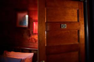 a door in a room with a sign on it at Crew's Quarters Boarding House - Caters to Men in Provincetown