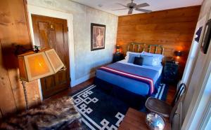 a bedroom with a bed and a television in it at Crew's Quarters Boarding House - Caters to Men in Provincetown