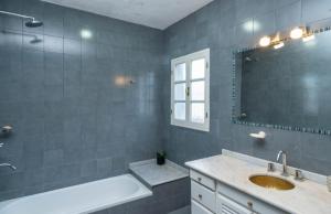 a bathroom with a tub and a sink and a mirror at Casa Salta in Salta