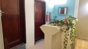 a bathroom with a sink with flowers on it at Justice Seaview Apartment in Le Morne