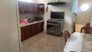 a small kitchen with a stove and a table at Justice Seaview Apartment in Le Morne