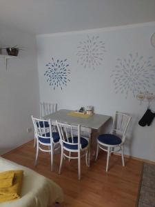 una sala da pranzo con tavolo e 4 sedie di Apartmá U rybníčku a Dolní Dunajovice