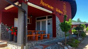 a restaurant with a wooden table outside of it at Selfness Rožňava in Rožňava