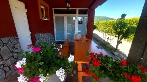 a porch of a house with flowers on it at Selfness Rožňava in Rožňava