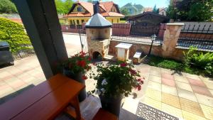 a view of a patio with a bench and flowers at Selfness Rožňava in Rožňava