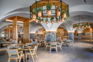 a restaurant with tables and chairs and a chandelier at Creta Maris Resort in Hersonissos