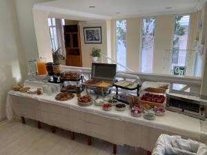 un buffet avec de nombreux types de nourriture sur une table dans l'établissement Grand Hotel Loutraki, à Loutraki