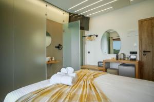 Voodi või voodid majutusasutuse Omnia Deluxe Rooms toas