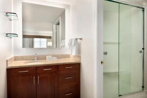 a bathroom with a sink and a glass shower at Residence Inn by Marriott Baltimore Downtown/ Inner Harbor in Baltimore